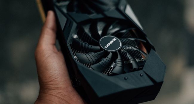 a person holding gpu in hand