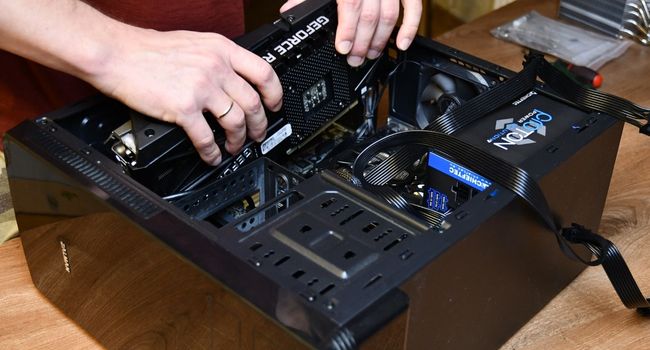 person replacing gpu in pc